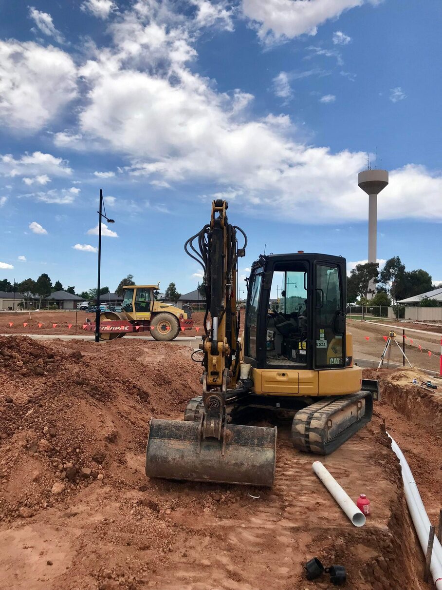 Mini excavator and roller on a subdivision site